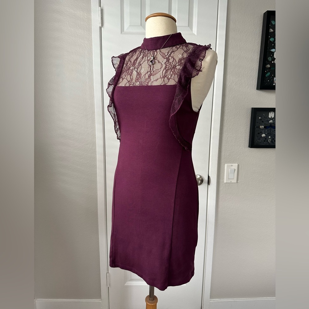 Mini dress with mock neck and lace inset.